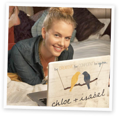 Merchandiser on her bed accessing her e-boutique at home on a laptop.